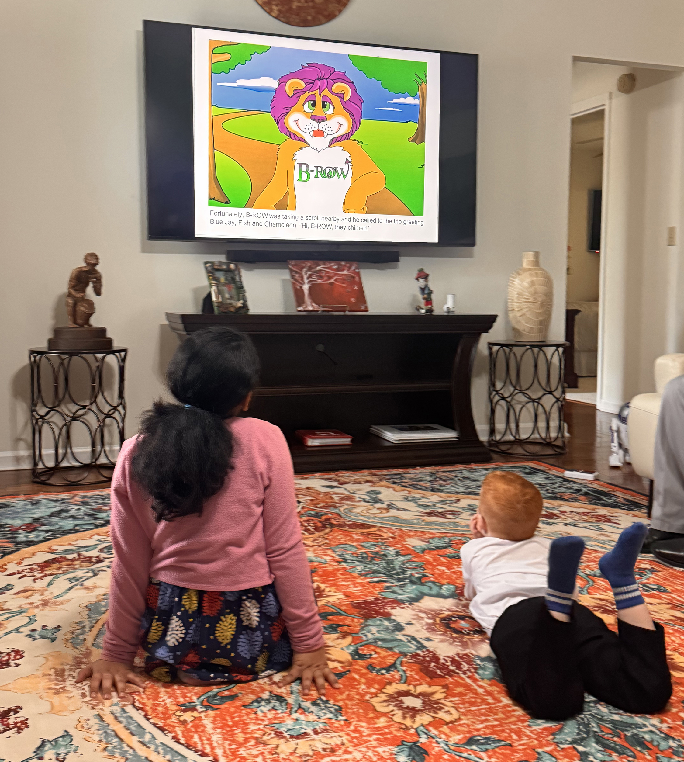 Children watching B-ROW animations on TV